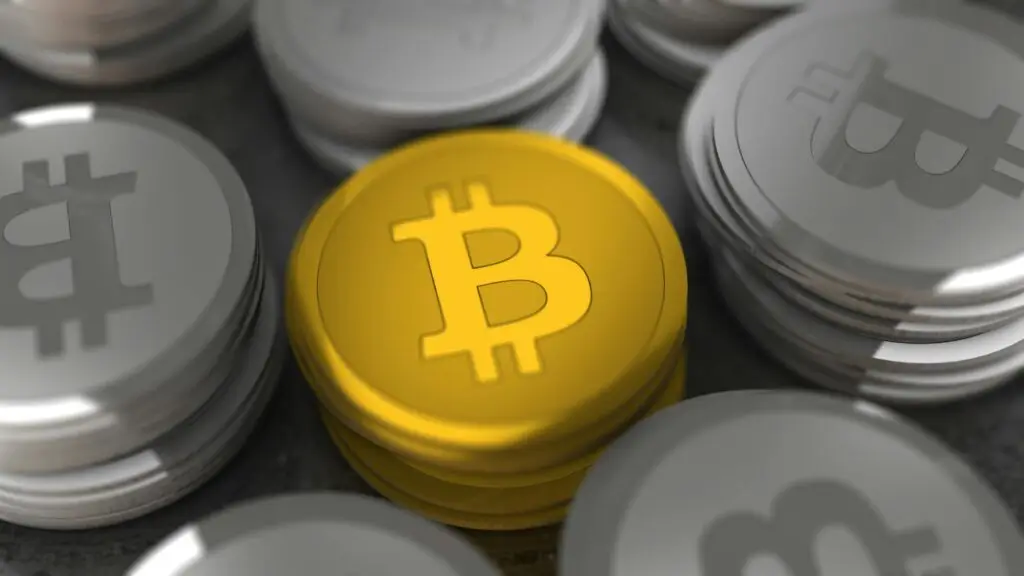 Golden and silver Bitcoin coins in a close-up shot, symbolizing cryptocurrency and digital money.